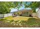 The home's backyard is fenced in and features a green lawn, patio, and view of the home's exterior at 611 Tee Ridge Ct, Fort Mill, SC 29715