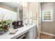 Bathroom featuring decorative clock, a framed mirror, and a sink vanity with white cabinets at 611 Tee Ridge Ct, Fort Mill, SC 29715