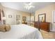Spacious bedroom featuring plush carpeting, a dresser, and a well-lit ensuite bathroom at 611 Tee Ridge Ct, Fort Mill, SC 29715