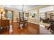 Dining room with hardwood floors and glass table, open to the living area at 611 Tee Ridge Ct, Fort Mill, SC 29715
