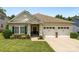Inviting single-story home showcasing a well-maintained lawn and an attached two-car garage at 611 Tee Ridge Ct, Fort Mill, SC 29715