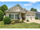 Charming single-story home with a two-car garage, manicured lawn, and tasteful landscaping at 611 Tee Ridge Ct, Fort Mill, SC 29715