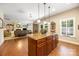 Open kitchen featuring a large island with granite countertop and hardwood floors throughout at 611 Tee Ridge Ct, Fort Mill, SC 29715
