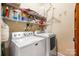 Functional laundry room with washer, dryer, and upper shelving for storage at 611 Tee Ridge Ct, Fort Mill, SC 29715