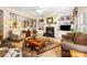 Cozy living room with a fireplace, built-in shelving, and comfortable seating at 611 Tee Ridge Ct, Fort Mill, SC 29715