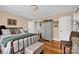 Relaxing bedroom with hardwood floors, a decorative chandelier, and a comfortable bed at 625 N Center St # 4, Statesville, NC 28677