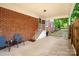 Attached carport with patio seating area, brick exterior wall, and lush garden views at 625 N Center St # 4, Statesville, NC 28677