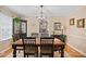 Elegant dining room featuring a wooden table, chandelier, and access to the kitchen at 625 N Center St # 4, Statesville, NC 28677