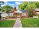 Quaint red brick home with green shutters, a chimney, a sidewalk and manicured lawn and plantings at 625 N Center St # 4, Statesville, NC 28677