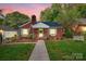 Charming brick home with a manicured lawn, flower boxes, and walkway leading to a light green front door at 625 N Center St # 4, Statesville, NC 28677