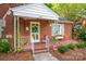 Welcoming front porch with a wreath on the mint-green door, shutters, flower boxes and alarm sign at 625 N Center St # 4, Statesville, NC 28677