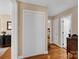 Hallway featuring hardwood floors and white closet doors with views to other rooms in the house at 625 N Center St # 4, Statesville, NC 28677