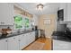Well-lit kitchen featuring white cabinets, stainless steel appliances, and a subway tile backsplash at 625 N Center St # 4, Statesville, NC 28677