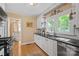 Classic kitchen with white cabinets, hardwood floors, and stainless steel appliances at 625 N Center St # 4, Statesville, NC 28677