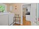 Well-organized laundry area with a washer and dryer near a kitchen area with white cabinetry and hardwood floors at 625 N Center St # 4, Statesville, NC 28677
