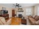 Inviting living room features a fireplace, hardwood floors, ceiling fan, and a comfortable sofa at 625 N Center St # 4, Statesville, NC 28677