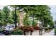 Beautiful street view lined with trees and planter boxes with colorful red flowers, enhancing the neighborhood's charm at 625 N Center St # 4, Statesville, NC 28677