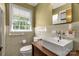 Light filled bathroom features a large window and farmhouse sink at 709 Plantation Rd, Lancaster, SC 29720