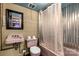 Retro basement bathroom with pink fixtures, including a unique sink and toilet, and metal shower surround at 709 Plantation Rd, Lancaster, SC 29720