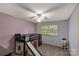 Bright bedroom featuring a unique loft bed with a slide, complemented by natural light from the window at 709 Plantation Rd, Lancaster, SC 29720