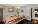 Bright dining room featuring a large wooden table, bench seating, and an elegant chandelier at 709 Plantation Rd, Lancaster, SC 29720