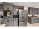 Cozy kitchen with stainless steel appliances and grey painted cabinetry at 709 Plantation Rd, Lancaster, SC 29720