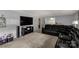 Cozy living room with comfortable leather seating, a large television, and plush carpeting at 709 Plantation Rd, Lancaster, SC 29720