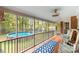 Spacious screened porch featuring a view of the pool and backyard area through the screen windows at 709 Plantation Rd, Lancaster, SC 29720