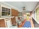 Inviting screened porch with rocking chairs, brick accents, a patterned rug, and a light blue ceiling at 709 Plantation Rd, Lancaster, SC 29720