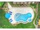 Aerial view highlighting a lagoon-style pool with spa, patio, and lounge area within a lush, landscaped backyard at 7812 Seton House Ln, Charlotte, NC 28277