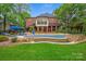 Charming backyard retreat with in-ground pool, sunbathing deck, and inviting outdoor living space at 7812 Seton House Ln, Charlotte, NC 28277