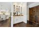 Stylish bar area with custom cabinets, granite countertop, and a sliding barn door at 7812 Seton House Ln, Charlotte, NC 28277