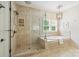 Well lit bathroom featuring shower, tub, window and neutral tones at 7812 Seton House Ln, Charlotte, NC 28277