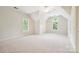 Large bedroom with vaulted ceiling and three windows at 7812 Seton House Ln, Charlotte, NC 28277