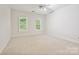 Well lit bedroom with carpet, fan and 2 windows with window shutters at 7812 Seton House Ln, Charlotte, NC 28277