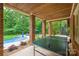 Covered patio featuring brick pillars, a view of the landscaped backyard and pool, and a ping pong table at 7812 Seton House Ln, Charlotte, NC 28277