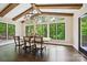 Bright dining room featuring wood beams, elegant chandelier, and large windows with scenic views at 7812 Seton House Ln, Charlotte, NC 28277