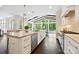 Spacious kitchen island with stainless steel appliances and seating overlooking bright dining area at 7812 Seton House Ln, Charlotte, NC 28277