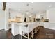 Bright kitchen with white cabinets, marble countertops, pendant lighting, and bar stool seating at 7812 Seton House Ln, Charlotte, NC 28277