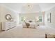 Spacious main bedroom with neutral decor, plush carpeting, and a sitting area at 7812 Seton House Ln, Charlotte, NC 28277