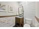 Stylish powder room with shiplap accent wall, rustic vanity, and modern fixtures at 7812 Seton House Ln, Charlotte, NC 28277