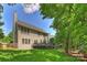 Home exterior with back deck, large yard, trees, and privacy fence at 7833 Taymouth Ln, Charlotte, NC 28269
