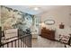 Charming Bedroom with a crib and a decorative mural on the wall, creating a serene atmosphere at 7833 Taymouth Ln, Charlotte, NC 28269