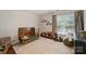 Cozy bedroom featuring a wooden crib, rocking chair, and ample space for play and relaxation at 7833 Taymouth Ln, Charlotte, NC 28269