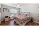 Bright bedroom with hardwood floors, a large window, and a cozy floral bedspread at 7833 Taymouth Ln, Charlotte, NC 28269