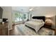 Spacious bedroom featuring a large bed, ceiling fan, and many windows for ample natural light at 7833 Taymouth Ln, Charlotte, NC 28269
