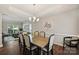Elegant dining room with wood floors, stylish chairs, and bright natural light at 7833 Taymouth Ln, Charlotte, NC 28269