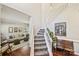 Elegant entryway with staircase, hardwood floors, and views into the living room at 7833 Taymouth Ln, Charlotte, NC 28269