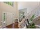 Bright foyer with a staircase, hardwood floors, and a large window at 7833 Taymouth Ln, Charlotte, NC 28269