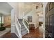 Grand two-story foyer showcasing hardwood floors, a staircase, and an elegant open concept design at 7833 Taymouth Ln, Charlotte, NC 28269